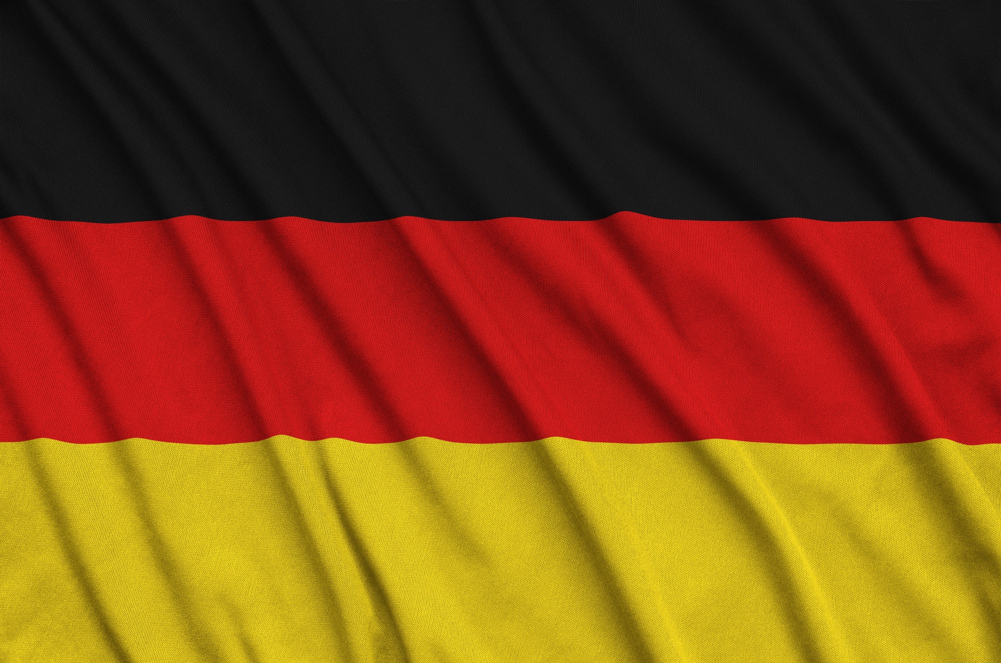 germany-flag-is-depicted-on-a-sports-cloth-fabric-with-many-folds-sport-team-waving-banner.jpg